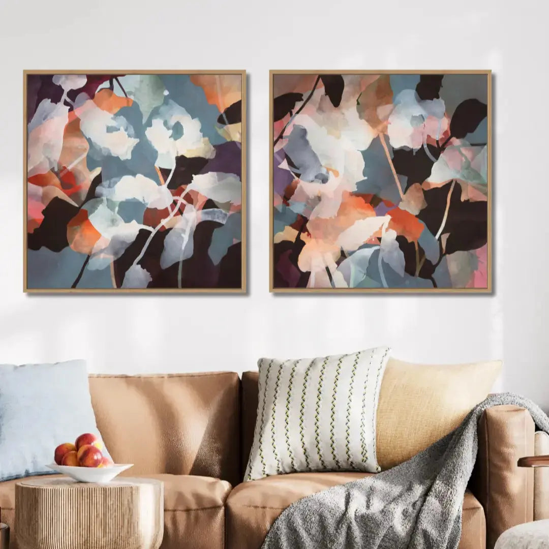 WILDFLOWERS canvas print diptych by Ida Kopperud on a wall above a sofa with decorative pillows and a small table.