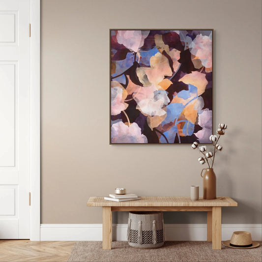 Abstract floral painting on a wall above a wooden bench with decorative items.