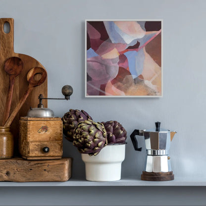 Decorative shelf with a coffee maker, artichokes, and a wooden mill against a gray wall with a colorful abstract painting.
