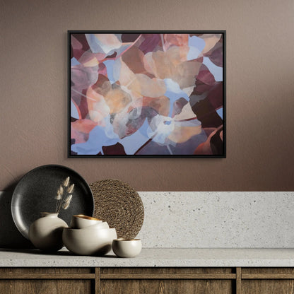 Abstract art piece on a wall above a wooden cabinet with decorative items.