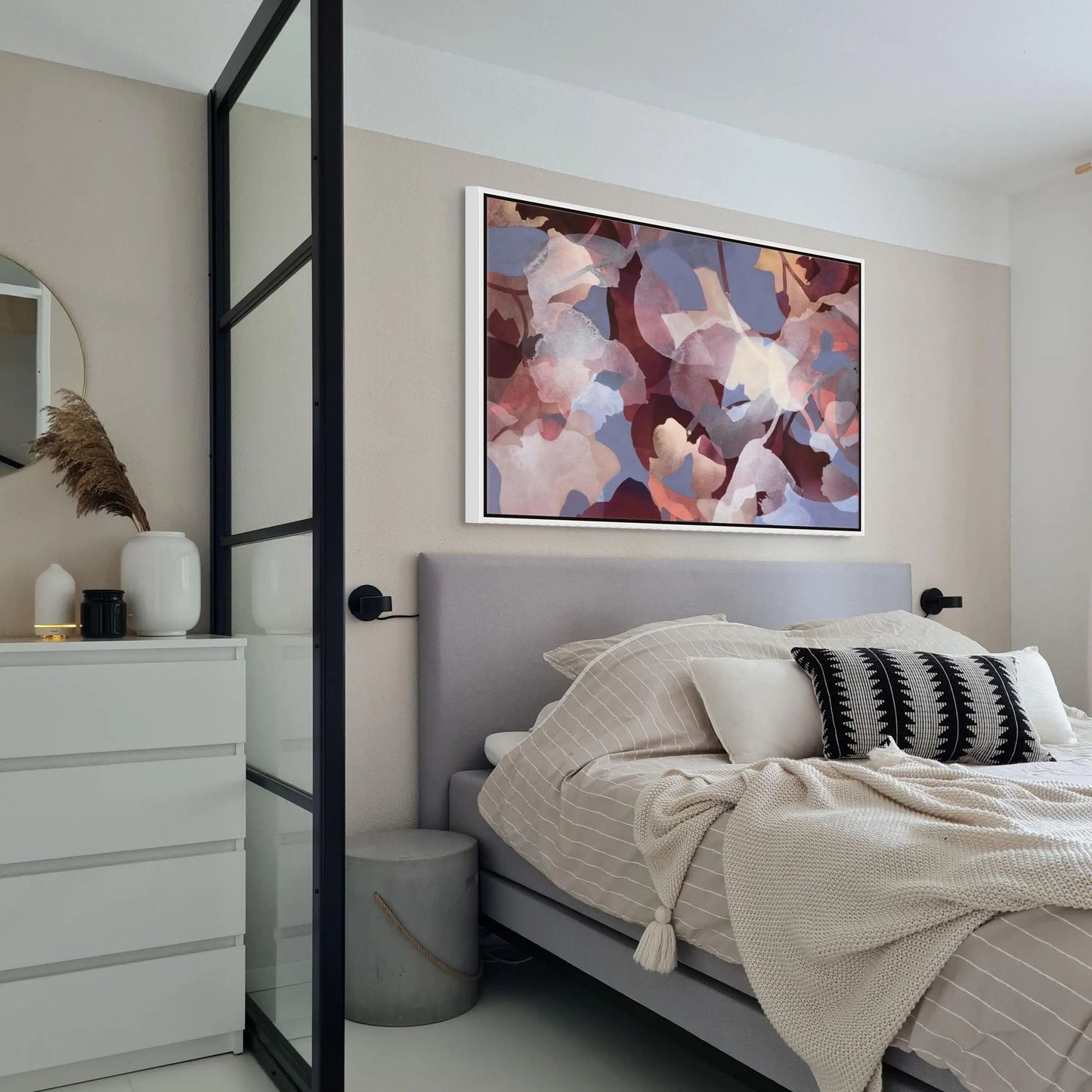 Modern bedroom with a bed, dresser, and abstract painting on the wall.