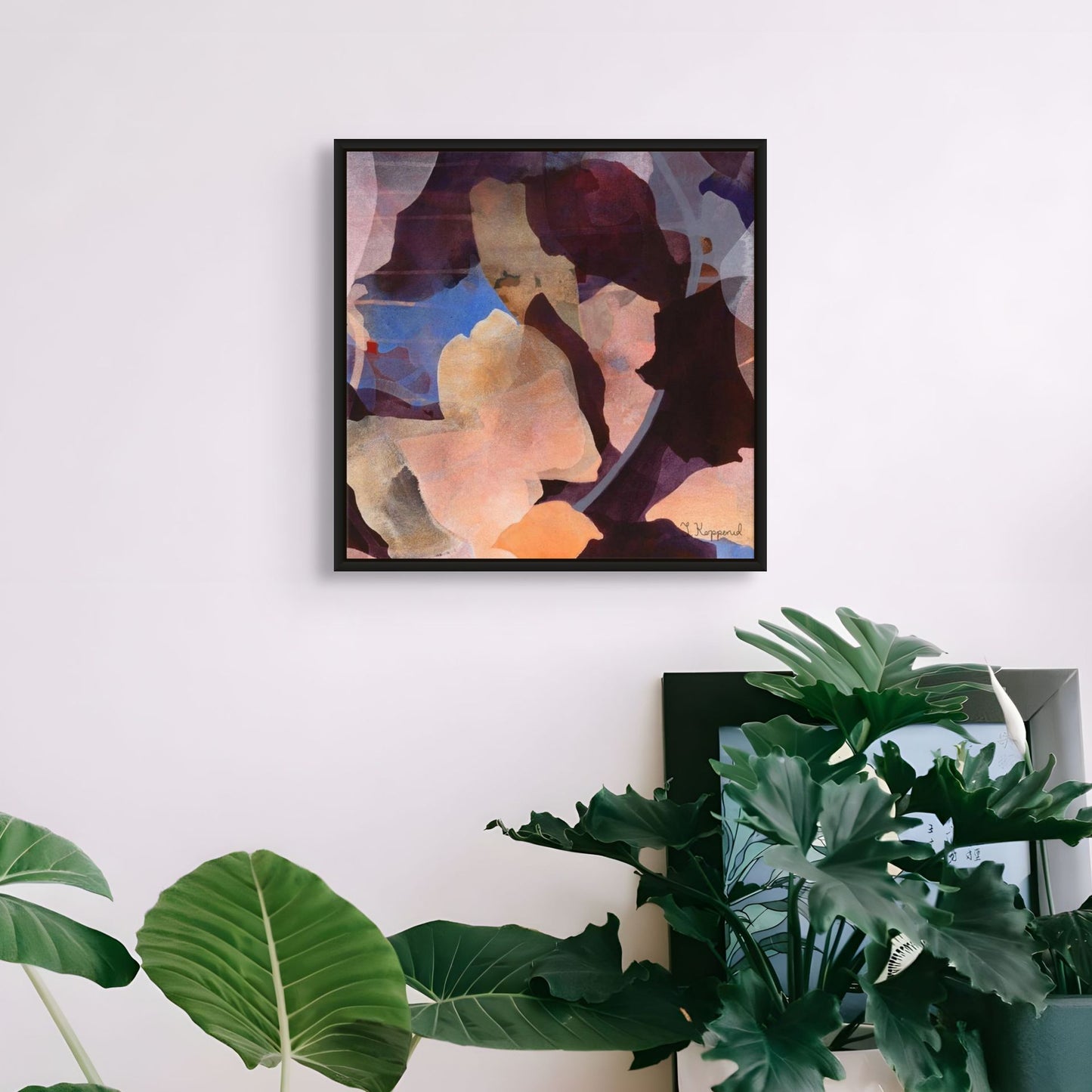 GROWTH botanical wall art canvas print in a black frame hanging above green plants