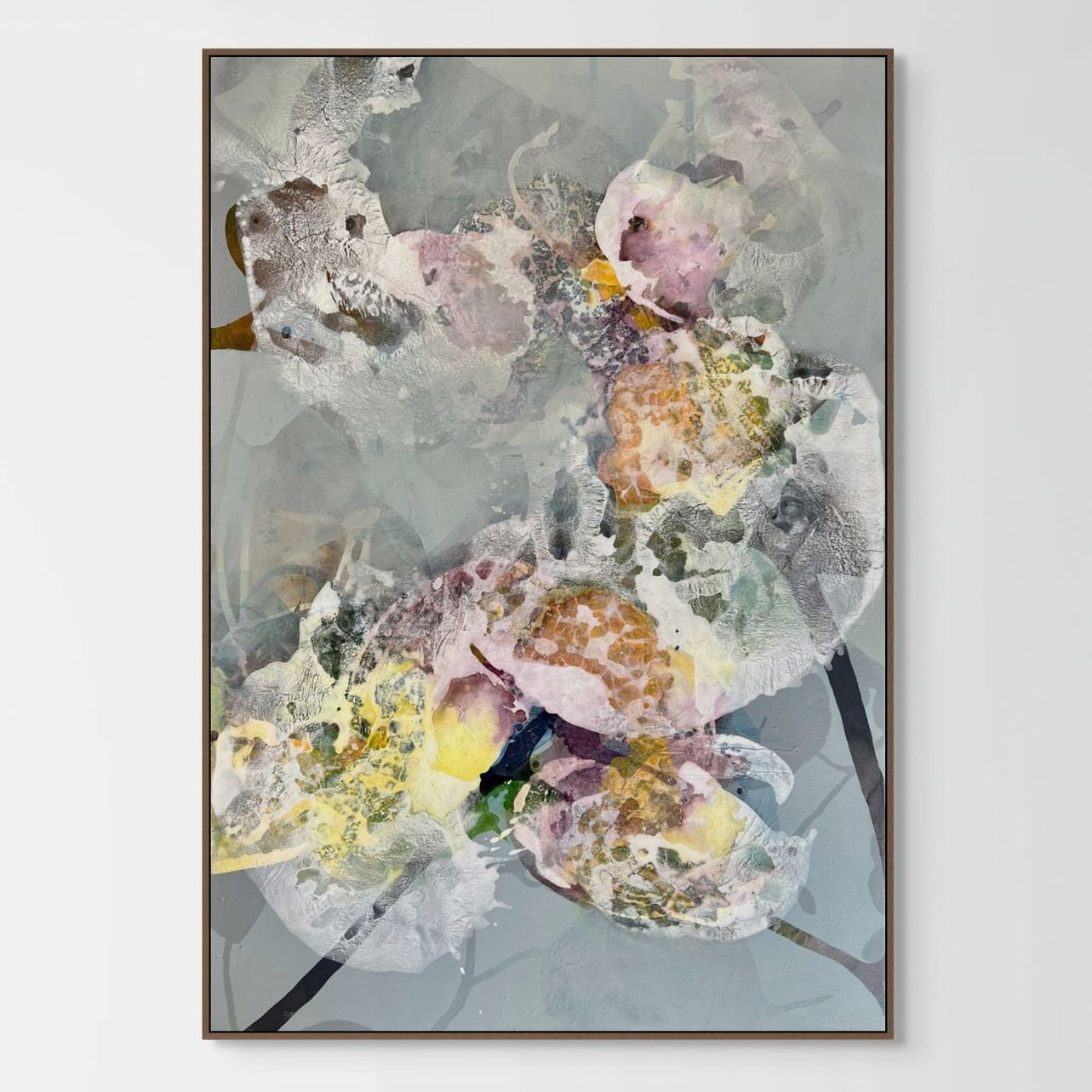Framed abstract floral artwork on a white wall