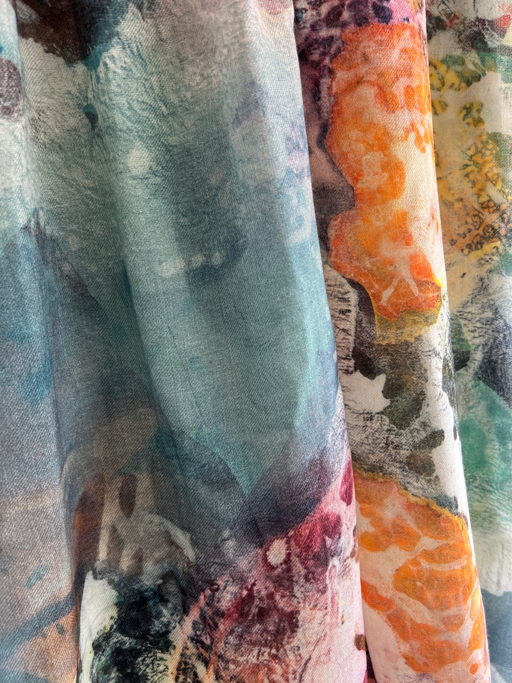 Close-up of colorful art scarf with abstract floral patterns