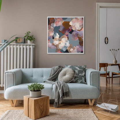 Modern living room with a light sofa, decorative pillows, and abstract colorful art on the wall.