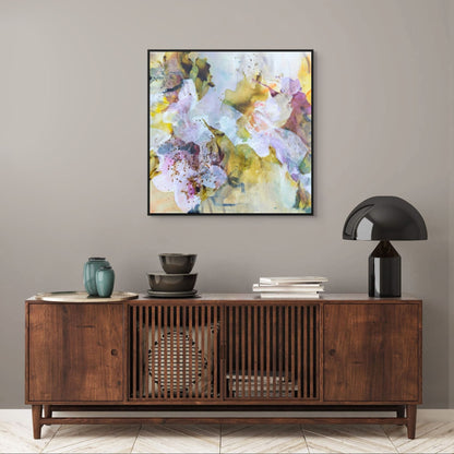 Framed abstract art above a wooden console table with decorative items.