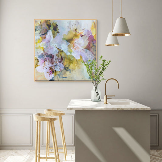 Modern kitchen with a floral painting on the wall, a sink, and a stool.