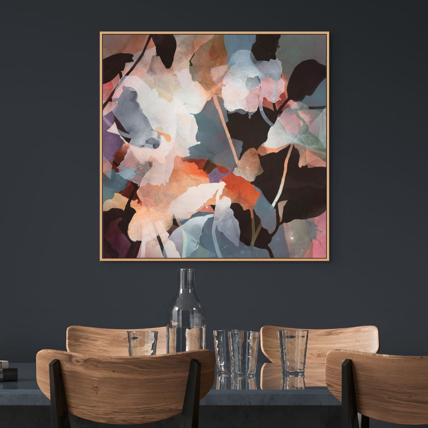 Abstract floral artwork on a dark wall above a dining table with chairs.